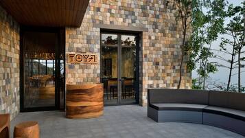A modern building with a stone facade and a wooden reception desk.