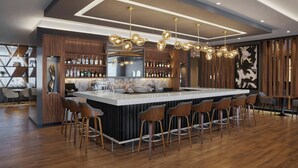 A modern bar area with a central island, bar stools, and a variety of bottles on shelves.