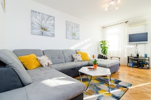 Relax in this stylish living room with a comfortable sofa, coffee table, and flat-screen TV.