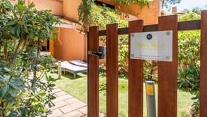 A wooden gate with a sign reading "Yellow House." - Yellow House with garden, 130 meters from the beach (Santa Margherita di Pula)