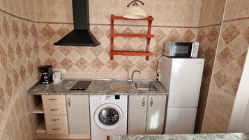 Standard Apartment, Partial Sea View | Private kitchen | Full-size fridge, microwave, stovetop, coffee/tea maker