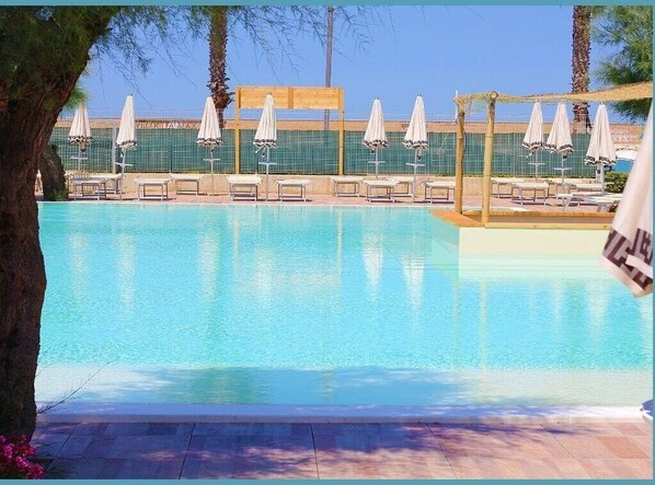 Seasonal outdoor pool, open 9:00 AM to 7:30 PM, pool umbrellas