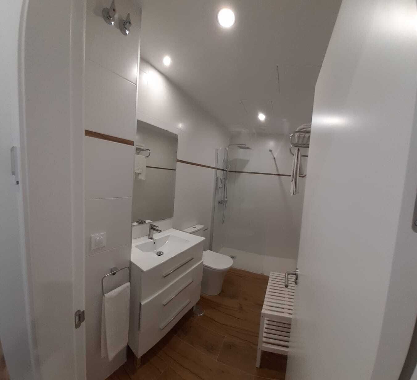 Badkamer | Een douche, een regendouche, een haardroger, handdoeken