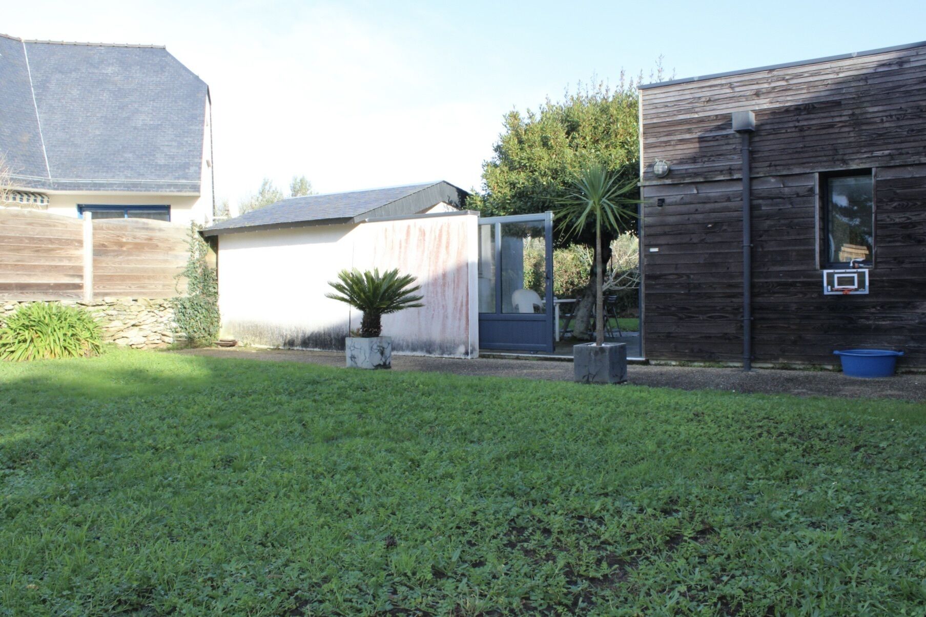 A residential property with a detached house, a garage, and a well-maintained lawn.