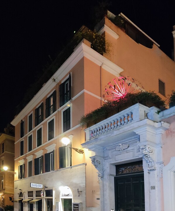 A building with a traditional facade, a visible entrance, and a street sign. - Stay in the heart of Rome (Roma)