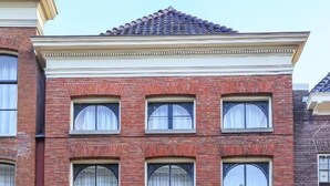 A two-story brick building with a sign reading "Hotel." - Hotel Halbert (Groningen)