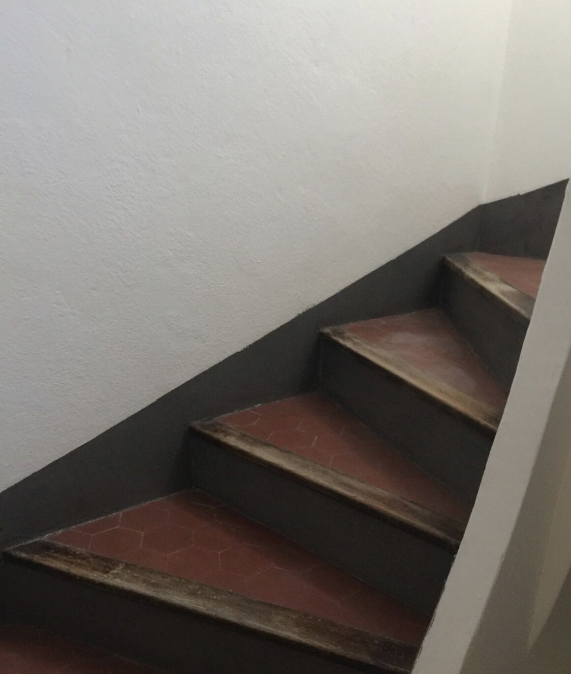 A staircase with wooden steps and dark walls.