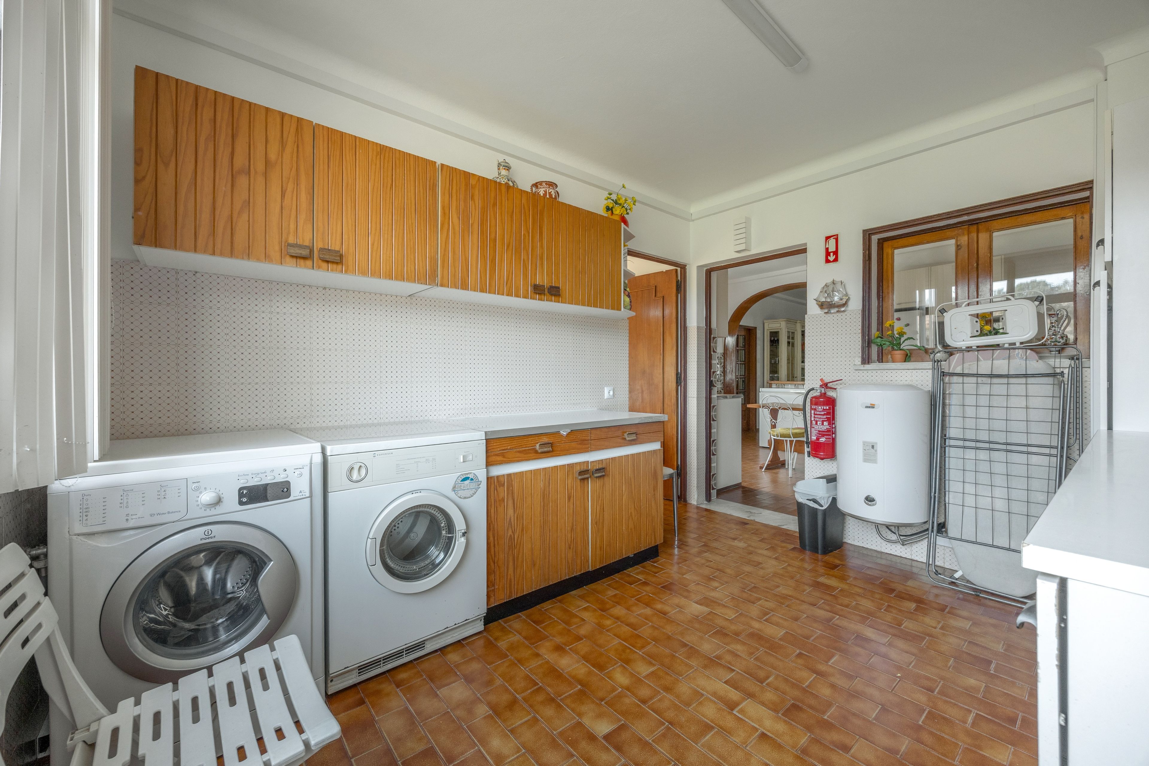 A laundry room with a washing machine, dryer, and a water heater.