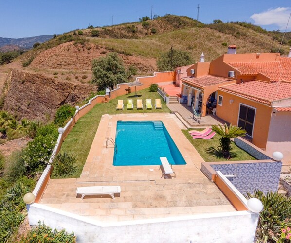 A residential property with a swimming pool, outdoor seating, and a view of the surrounding hills. - Villa with Private Pool and Terraces – Perfect Holiday in Portimão (Portimão)