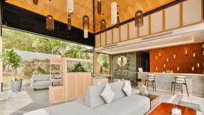 A modern hotel lobby with a sofa, bar area, and a reception desk. - Woda Villa & Spa (Batam)