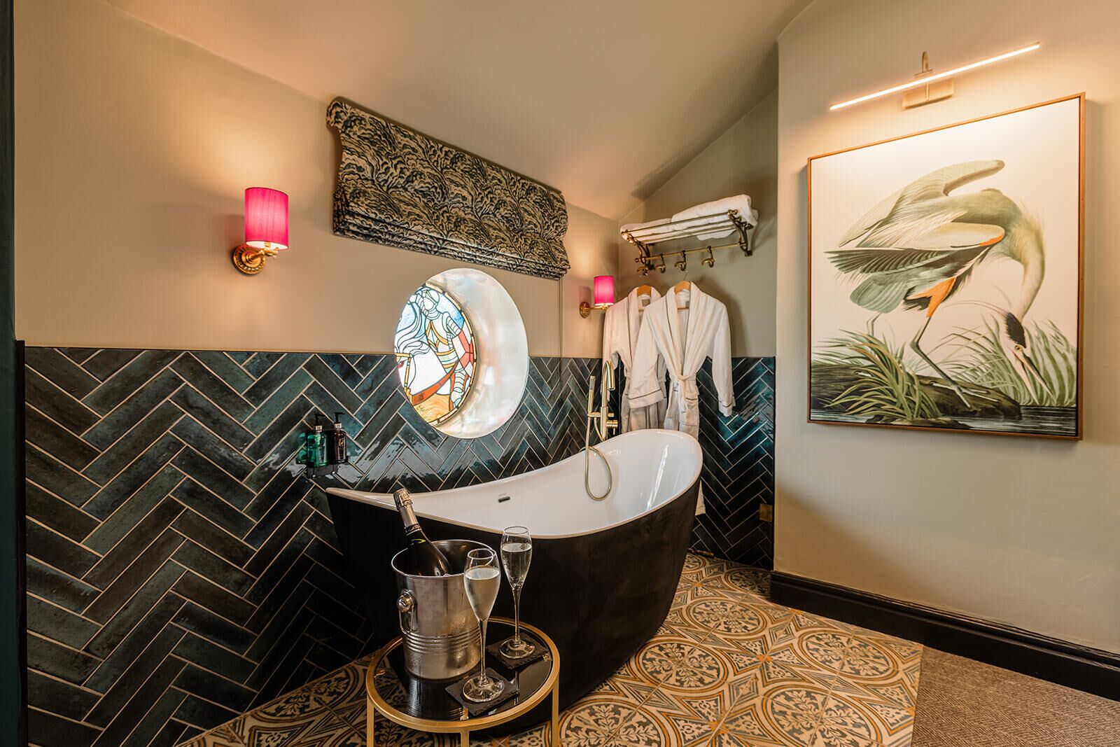 A modern bathroom with a freestanding bathtub, a large mirror, and a wall-mounted towel rack.