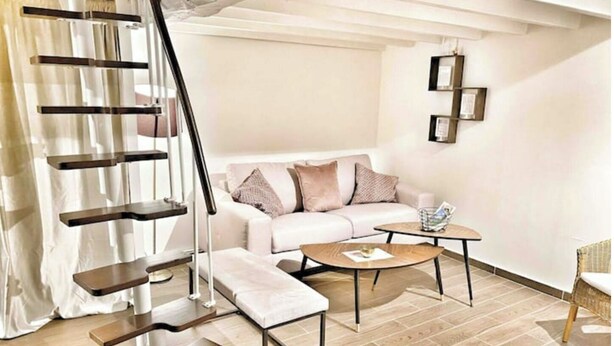 A modern living room with a white sofa, a coffee table, a staircase with a cat tree, and a wall-mounted picture frame. - ⭐️⭐️🇫🇷PARIS/BORGET✈️CDG/VILLEPINTE/ASTERIX/STADE DE FRANCE/DISNEYLAND🇫🇷⭐️⭐️ (Garges-lès-Gonesse)