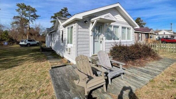 A single-story house with a front porch, a mailbox, and a number '5461' on the door.