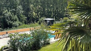 A pool area with a view of a forested hill.
