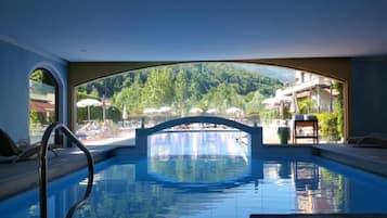 Una piscina al aire libre de temporada, sombrillas