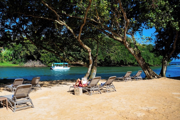 Beach nearby, white sand, beach towels, beach volleyball