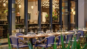 A restaurant with checkered chairs and tables set for dining. - Ocean’s Creek Beach Hotel Mauritius (Balaclava)