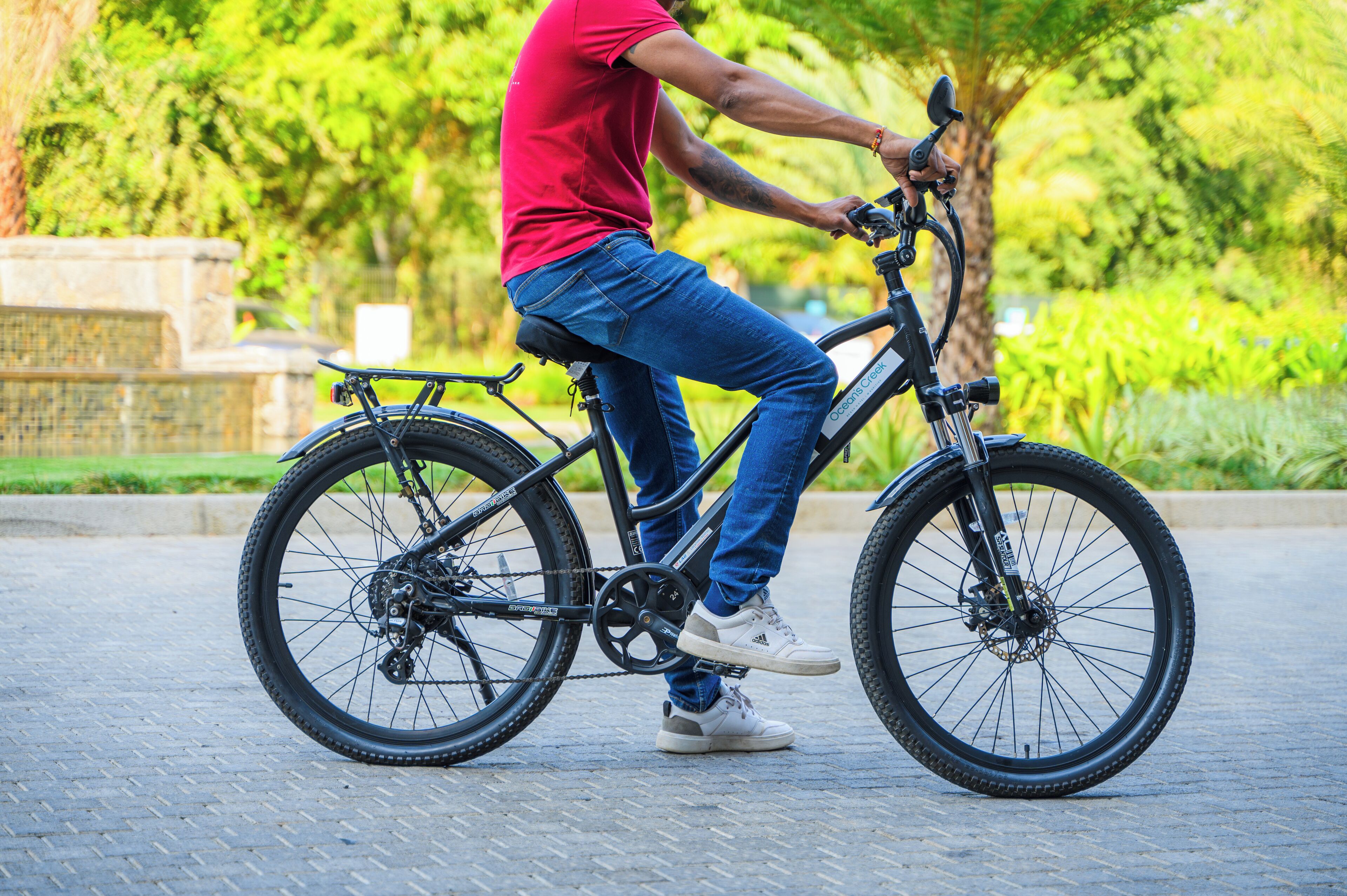 A person riding a bicycle on a paved path.
