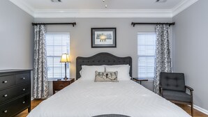 A bedroom with a large bed, a nightstand, a chair, and a dresser. - Entire Home in Hamburg! (Lexington)