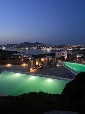 Relax by the pool and enjoy scenic views of the sea and city.