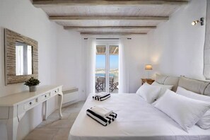 Relax in this serene retreat with a large bed, desk, and balcony offering a stunning sea view.
