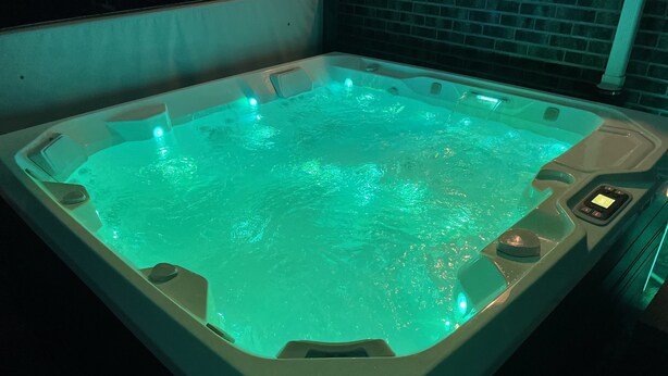 A rectangular hot tub with a built-in control panel and a small digital display. - 15 min drive to Mile High! Sleeps 12! (Arvada)