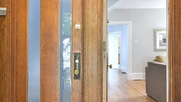 A wooden door with a glass panel and a doorknob.
