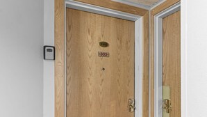 A wooden door with a brass plate marked "303" and a keyhole. - One BDR In Heart of Park City! (Park City)