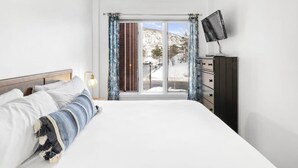 A bedroom with a large bed, a dresser, a TV, and a window with curtains. - One BDR In Heart of Park City! (Park City)