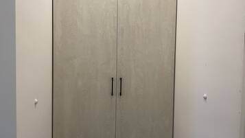 A closed wardrobe with two handles.