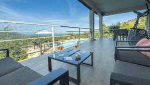 A modern outdoor terrace with a pool, seating area, and exercise equipment. - Villa Mayas - Scopello with private pool (Castellammare del Golfo)