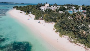 On the beach, white sand, free beach cabanas, sun-loungers