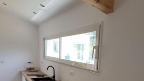 A narrow kitchen with a wooden countertop, a window, and a sink. - Uzes (8km), lovely guest house with swimming pool. (Serviers-et-Labaume)