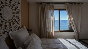 A bedroom with a bed, a decorative wall panel, and a window with curtains. - Altea Beach Front 'Oden 5' < 4 persons (Altea)