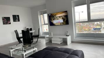 Panoramic Apartment | Living area | 65-inch Smart TV with cable channels, TV, Netflix