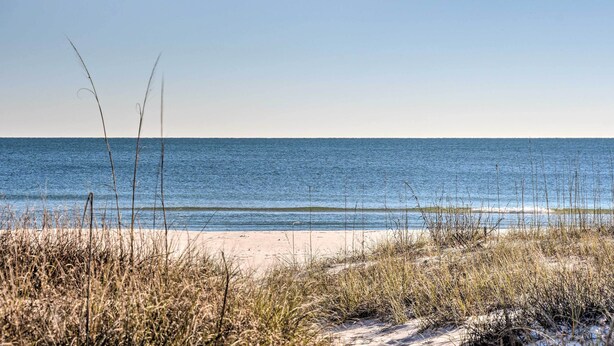 A beach with clear skies and calm waters. - Gulf Shores Rental w/ Large Porch - Beach View! (Gulf Shores)
