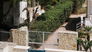 A coastal property with stone walls, a paved pathway, and a view of the sea. - apuliablue (Bari)
