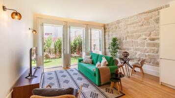 Premium Apartment, Garden View | Living area | 55-inch Smart TV with cable channels, TV