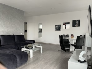 Signature Penthouse | Living area | 65-inch Smart TV with cable channels, TV, video-game console