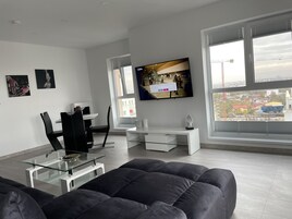 Signature Penthouse | Living area | 65-inch Smart TV with cable channels, TV, video-game console