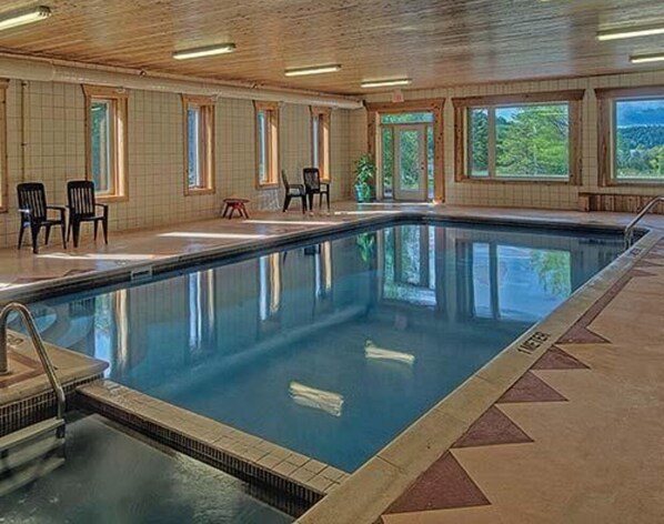 Relax by the pool surrounded by a patterned tile design and comfortable seating.