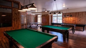 Enjoy a game of pool or foosball in this well-lit room with two tables.