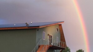 A house with a balcony and a rainbow in the sky. - Snow Capped MTN View & Starry Nites: 1 hour to Great Sand Dunes & Monarch Skiing (Crestone)