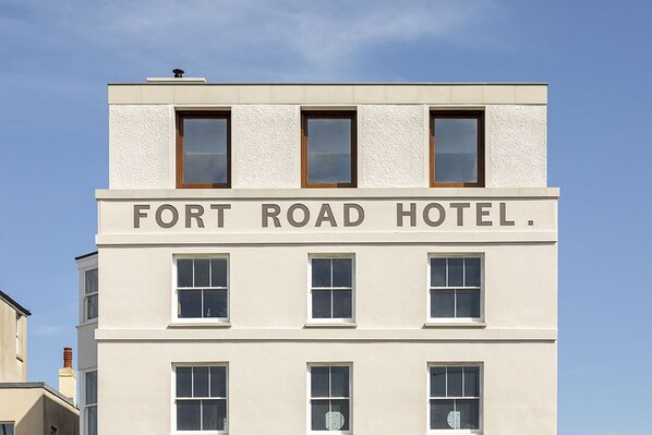 A building with the sign "FORT ROAD HOTEL." It has multiple windows on each floor and a flat roof. - Fort Road Hotel (Margate)