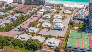A coastal residential area with multiple two-story houses, a beach, and a hotel. - Sea Cabins 2B - Newly Renovated, Heated Community Pool, Deeded Beach Access! (Miramar Beach)