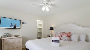 A bedroom with a bed, a television, a dresser, and a ceiling fan. - Sea Cabins 2B - Newly Renovated, Heated Community Pool, Deeded Beach Access! (Miramar Beach)