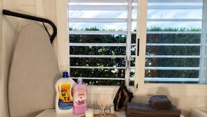 A laundry area with two washing machines, a drying rack, and a window with a view of greenery. - Villa Berria, 9 Pool / BBQ / Your Oasis near Palma (Es Pont d`Inca)