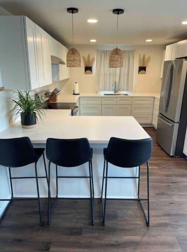 Functional kitchen with a spacious island, sleek cabinetry, and modern appliances.