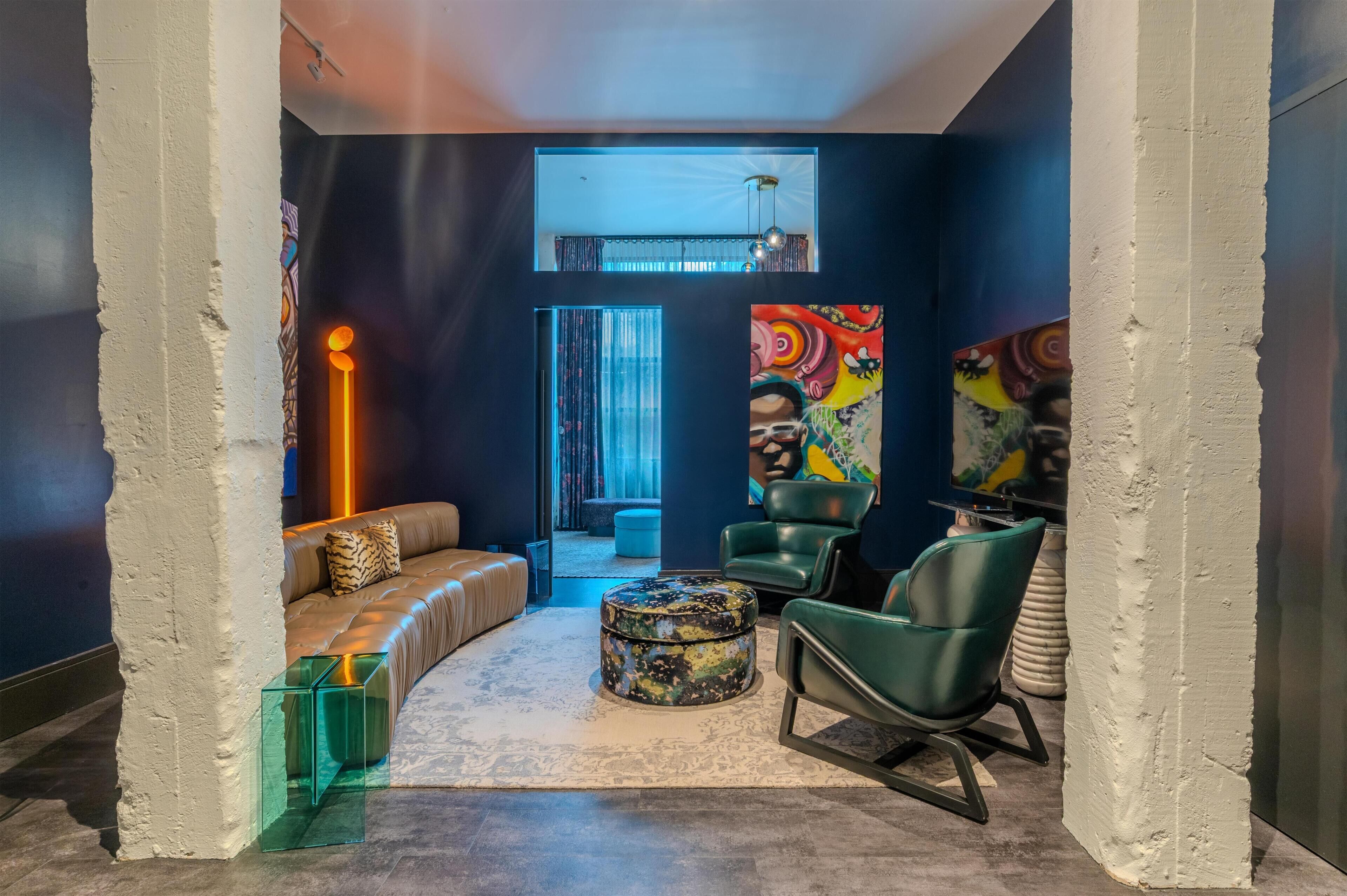 A modern lounge with a sofa, chairs, and a coffee table.
