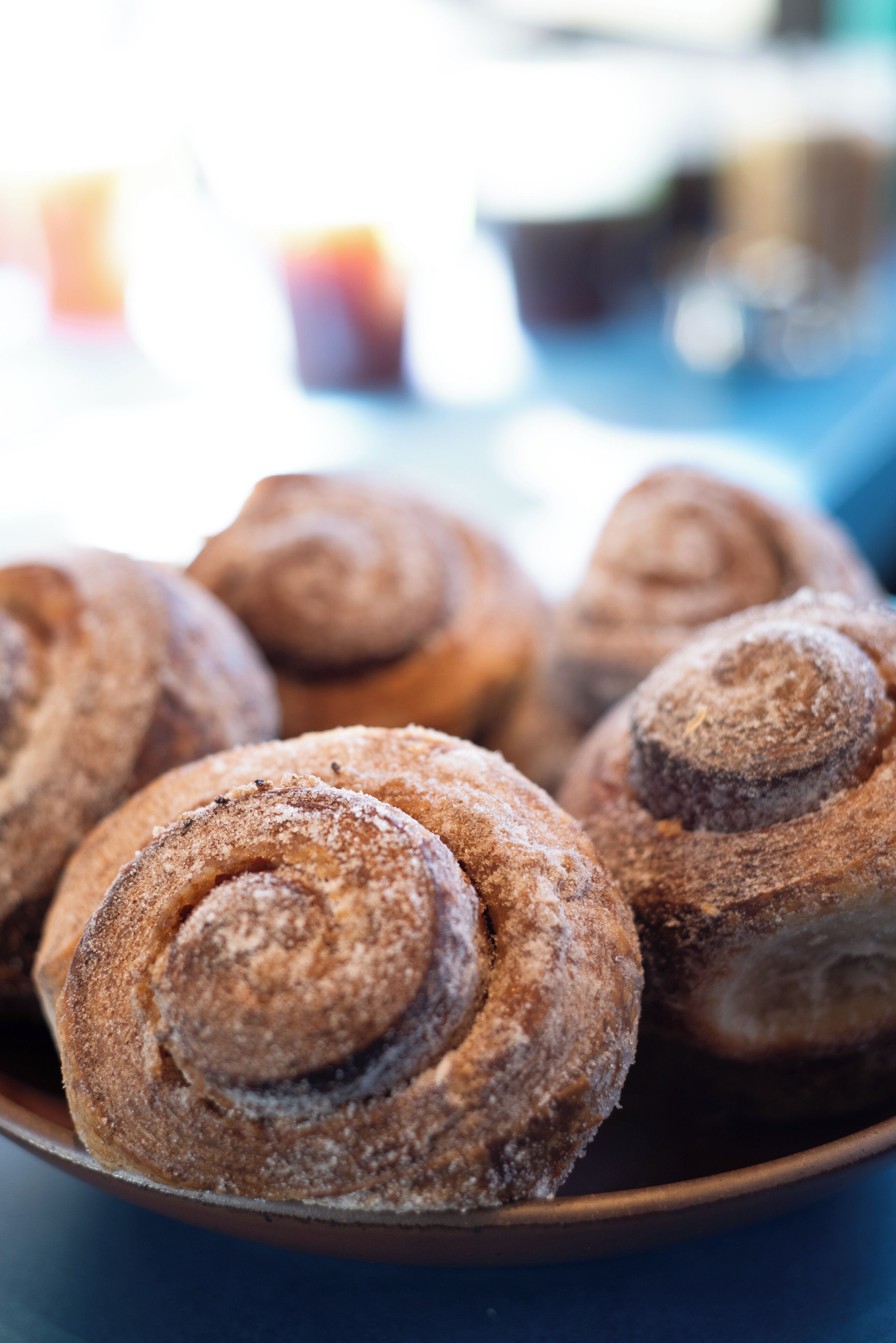 A close-up of cinnamon rolls in a bowl.